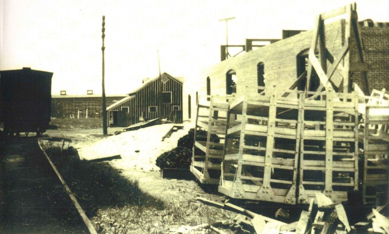 Looking out at the railroad malt car at the Stevens Point Brewery _the new bottle house on the right_ ca_1903_.jpg